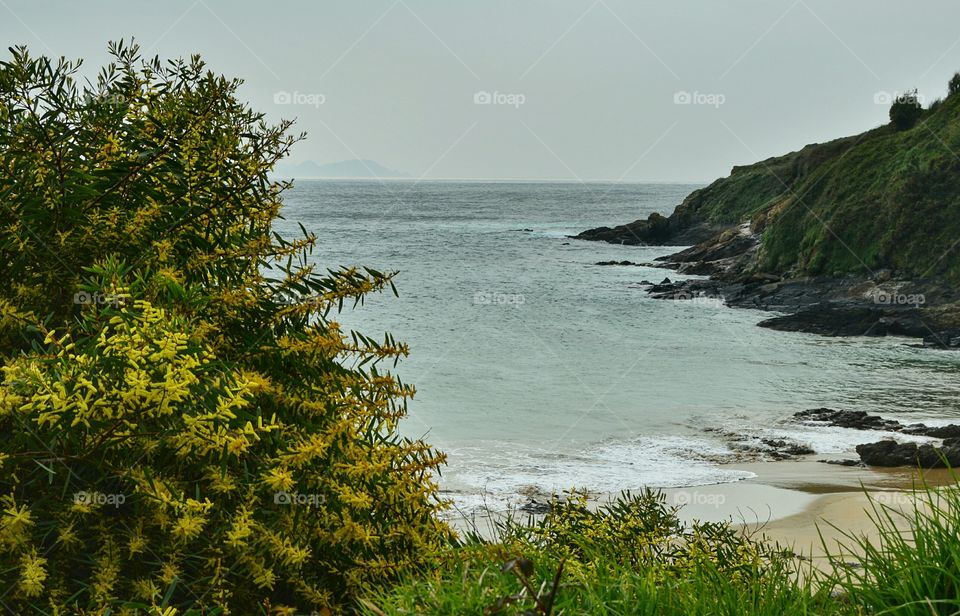 Scenic view of cliff in sea