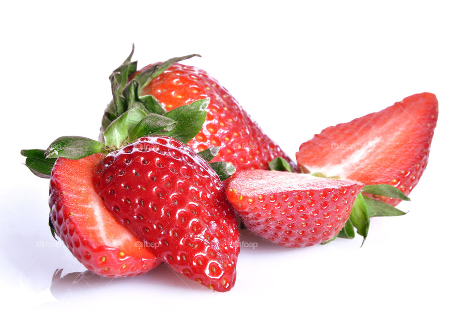 Halved strawberries against white background