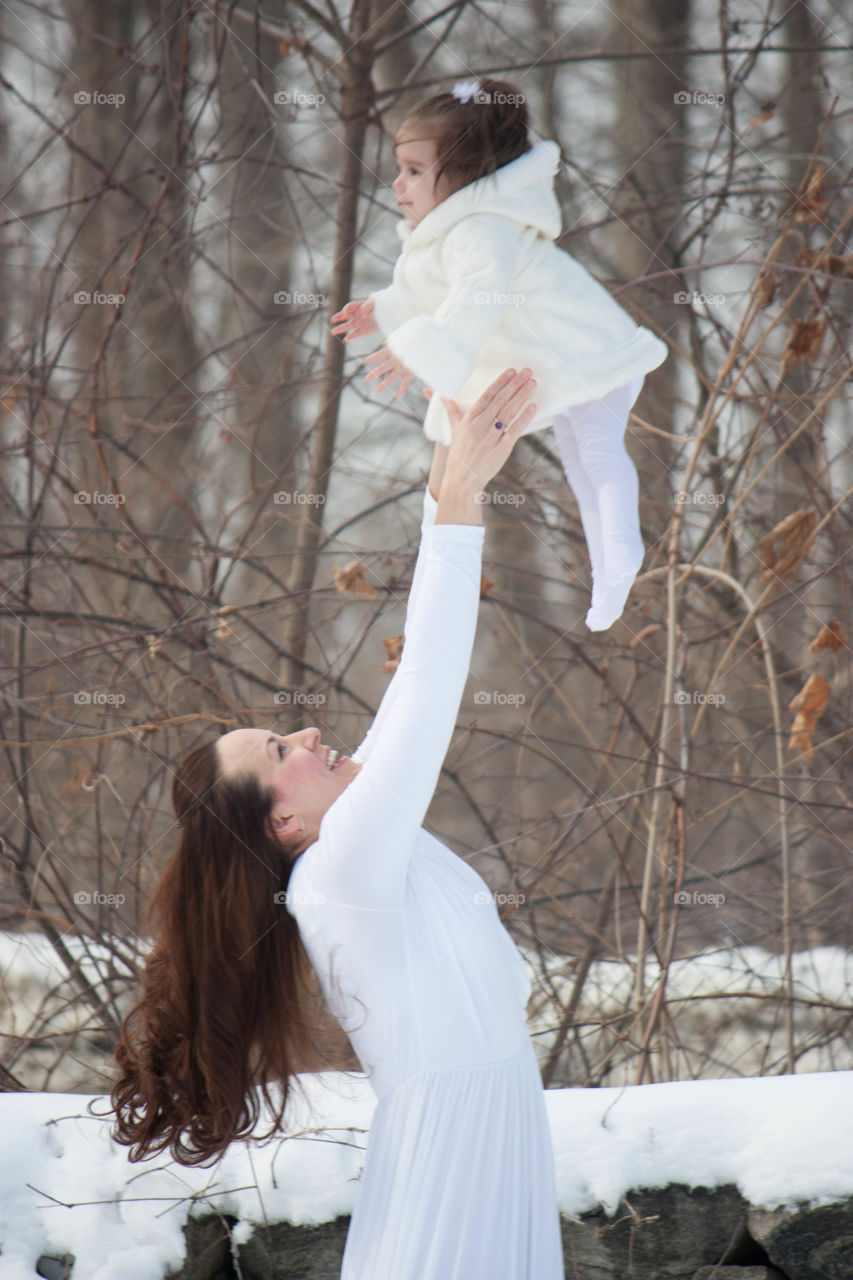 Mother catching her cute baby girl