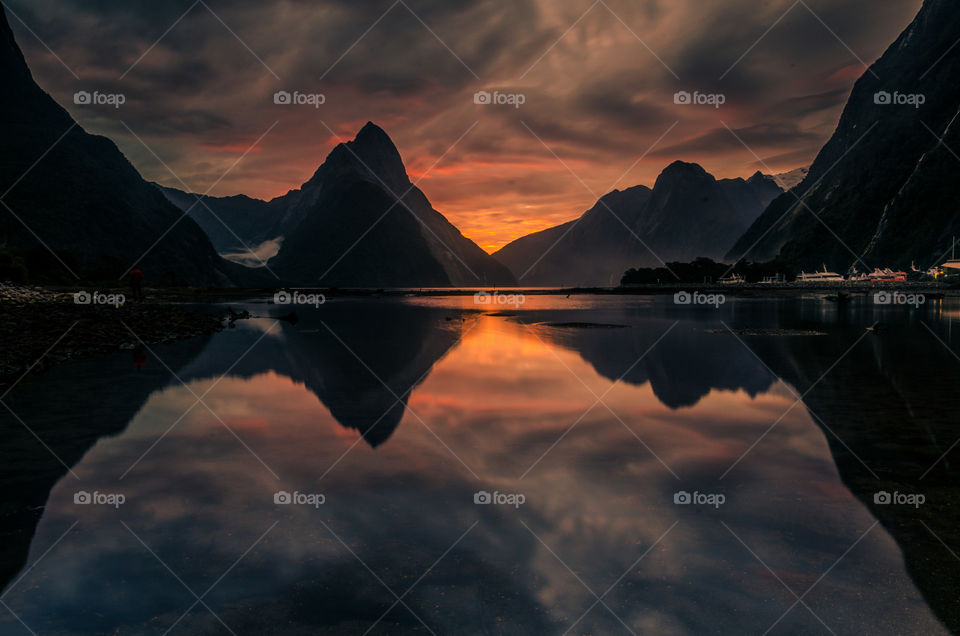 Winter sunset over the tranquil waters of Milford Sound, Fiordland National Park, New Zealand