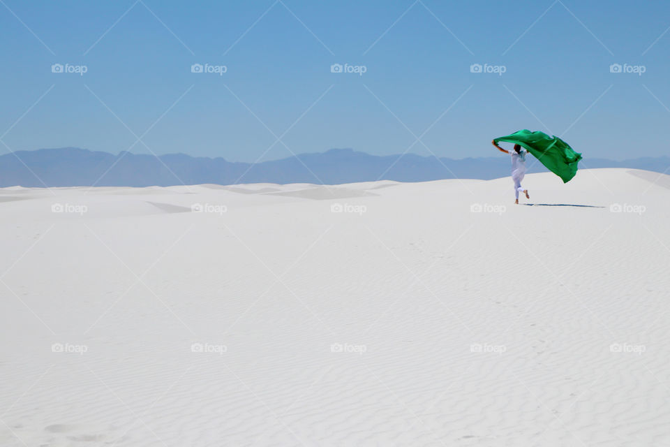 Women running on white sand