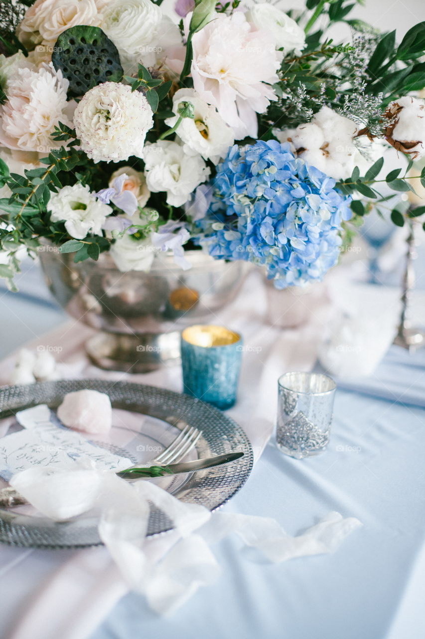 Graphic arts of beautiful wedding calligraphy cards and silver plate with cutlery on festive wedding table. 