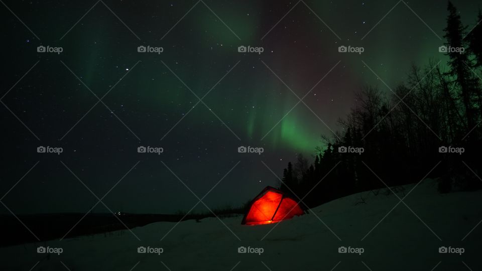 View of illuminated tent and northern lights