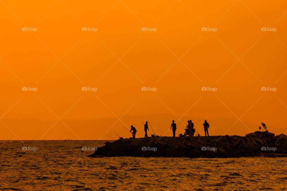 Silhouette of fisherman at the sea