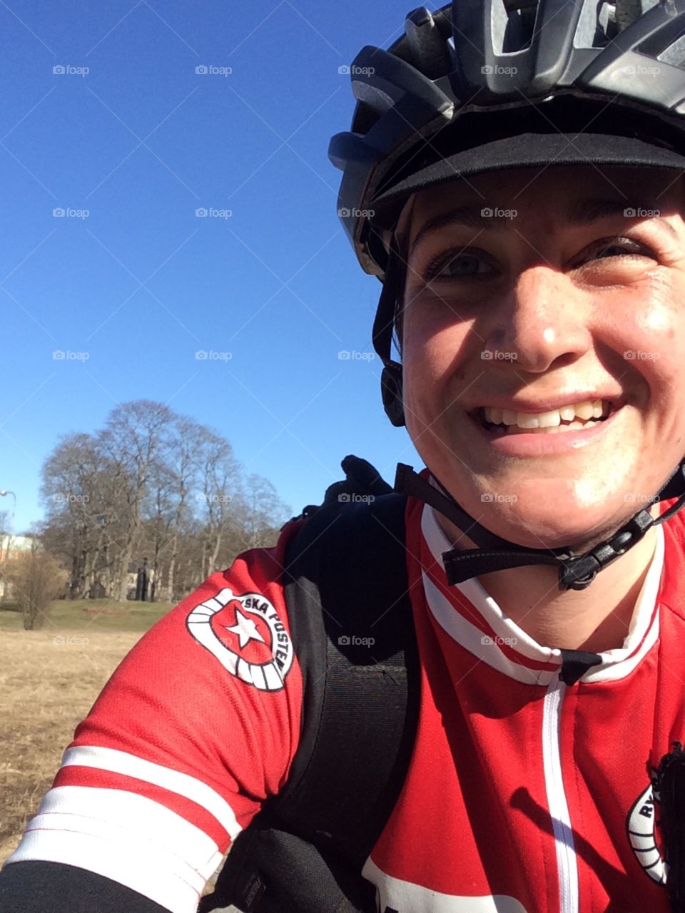 Selfie of happy courier on bike