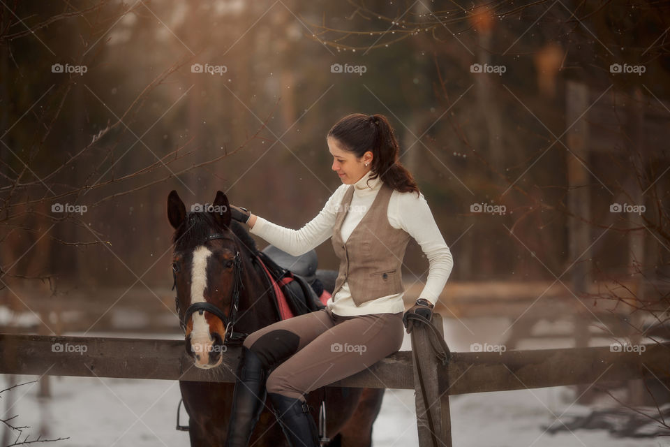 Young beautiful woman with horse outdoor portrait at spring day