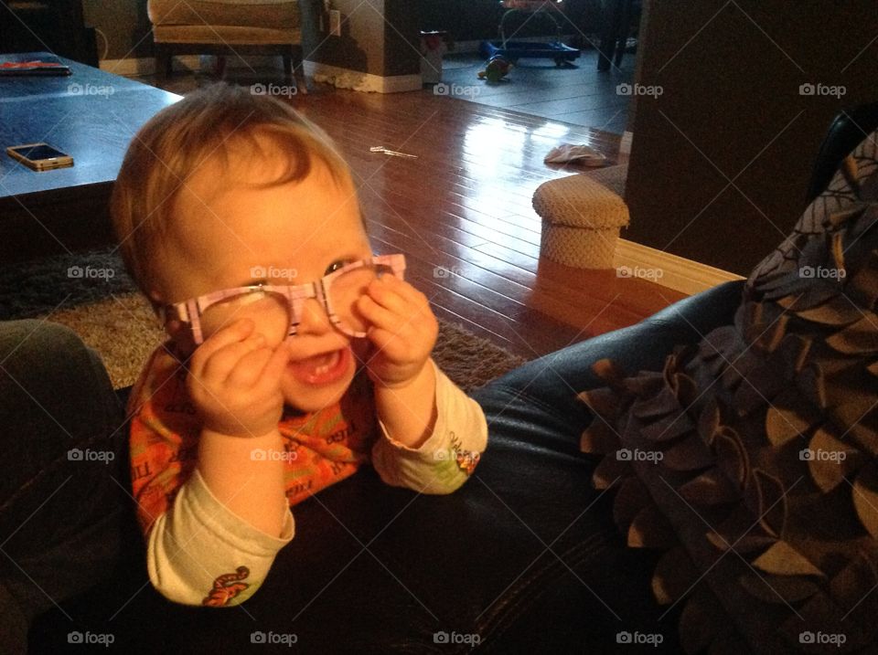 Funny baby trying in glasses