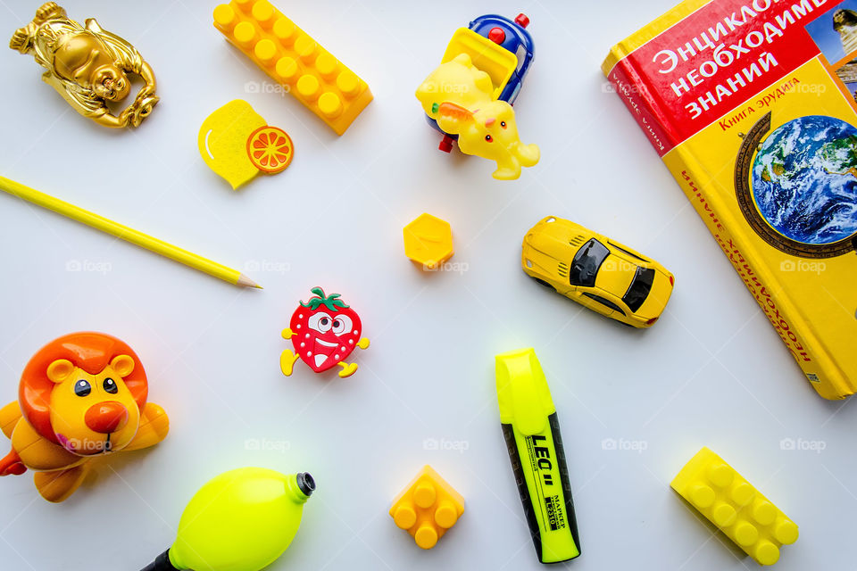 flat lay item of yellow things and toys