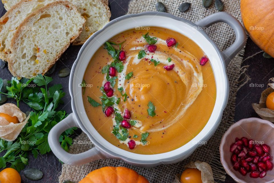 vegan pumpkin soup with cranberries and coconut milk