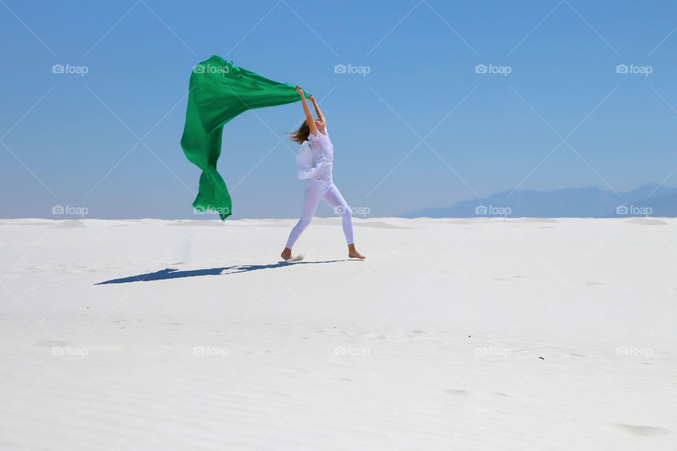 Woman with scarf blowing in air
