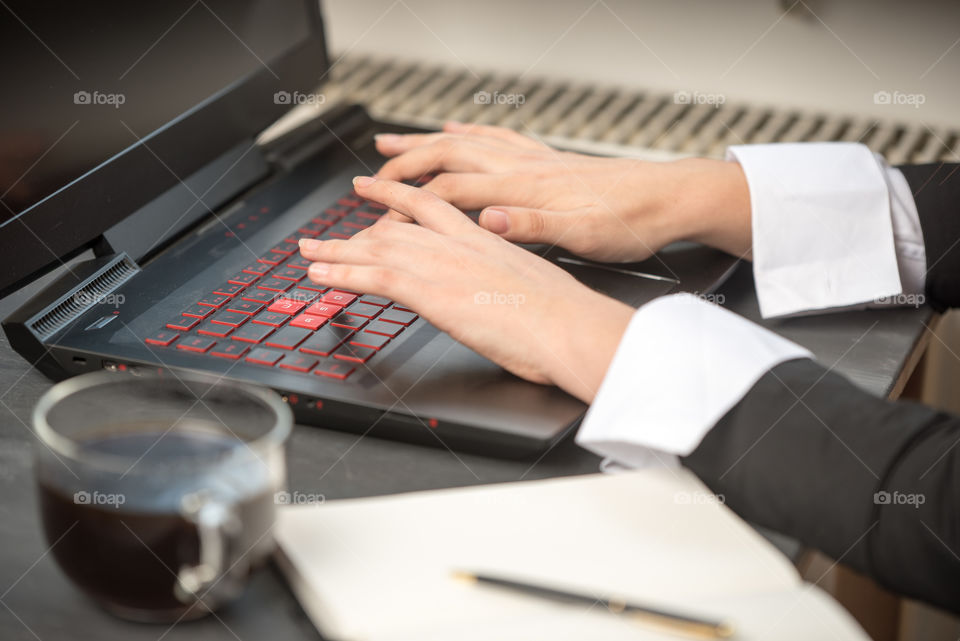 womans hands on laptop