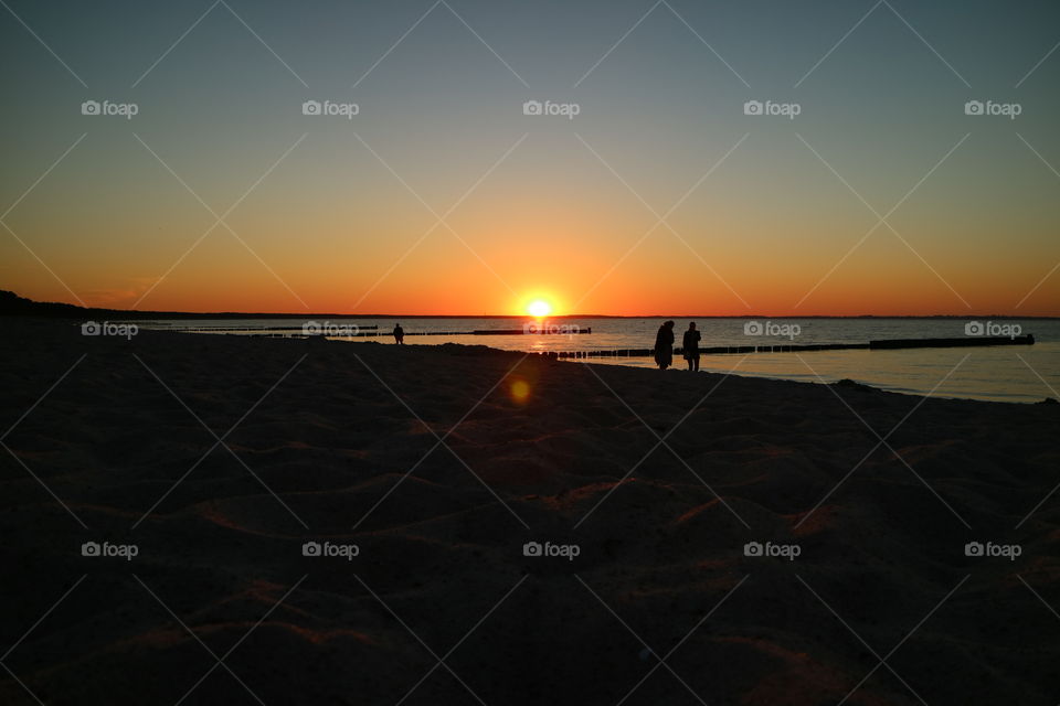 Hike in fantastic sunset mood on the beach of Glowe on the island of Rügen in Germany in summer