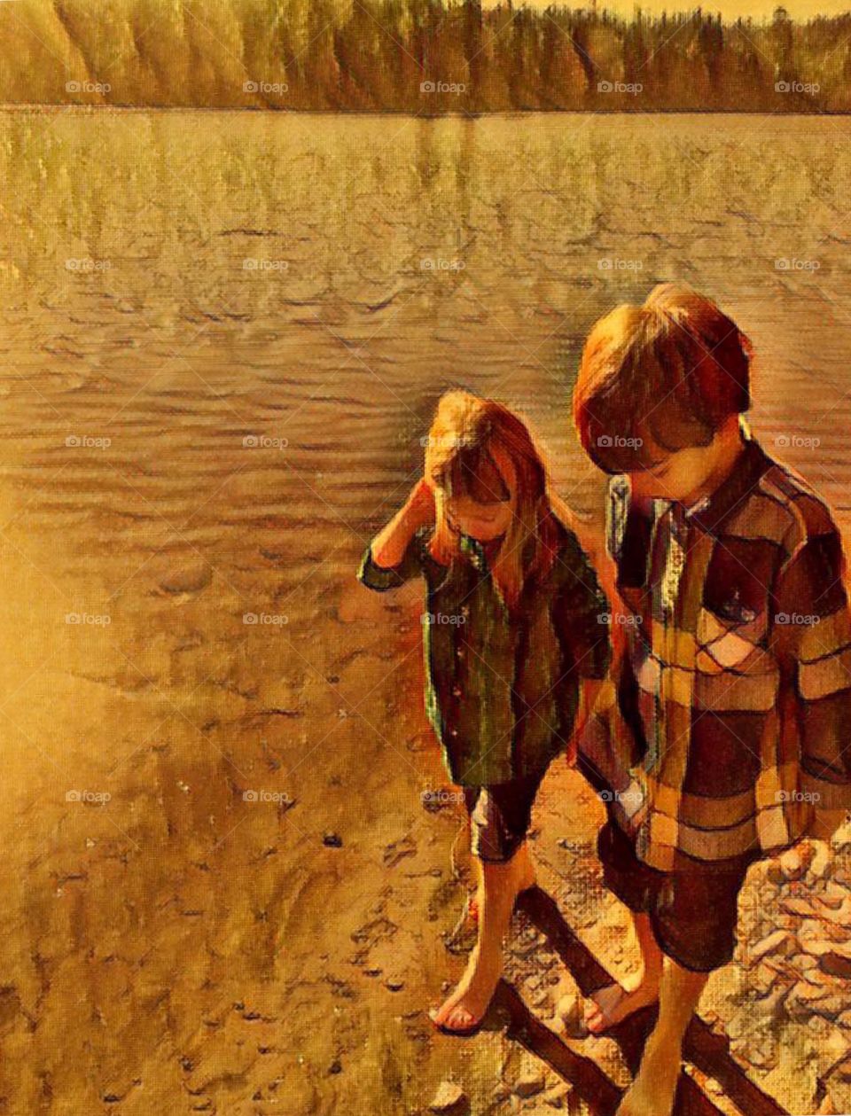 Brother and sister standing at lake shore