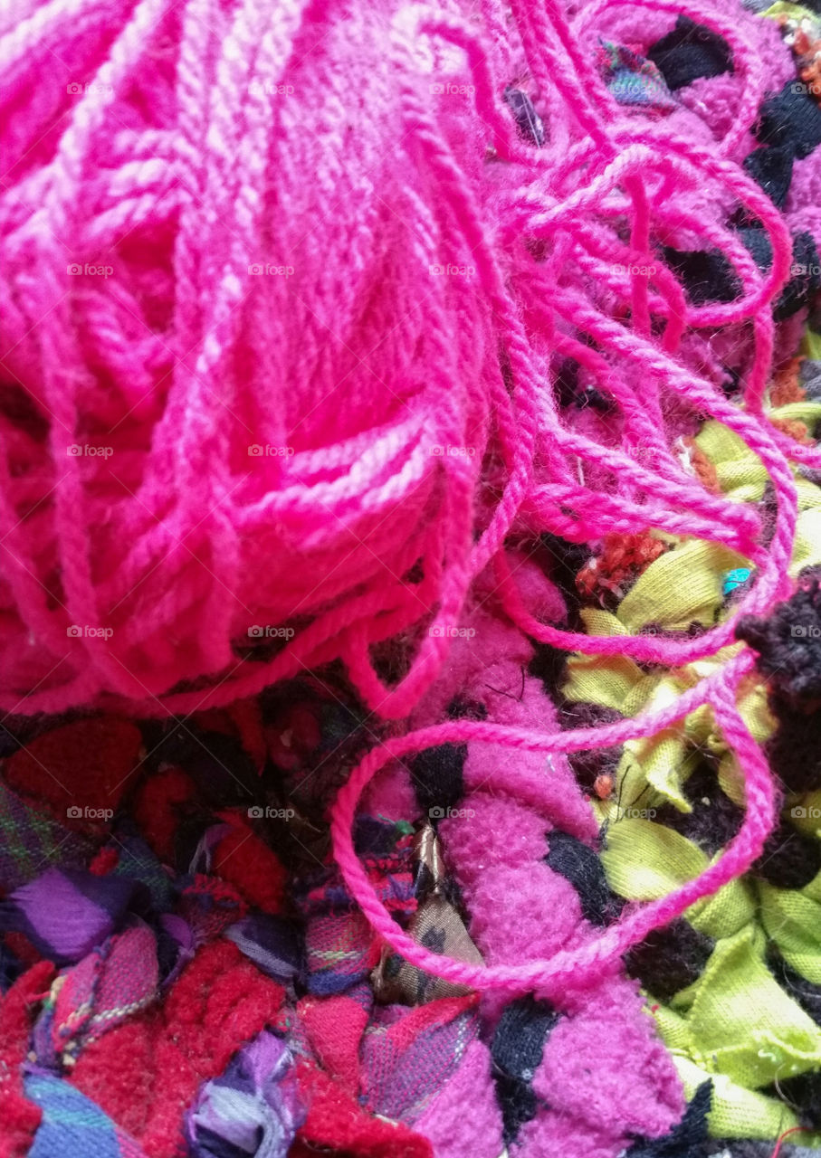 pink yarn and a rag rug