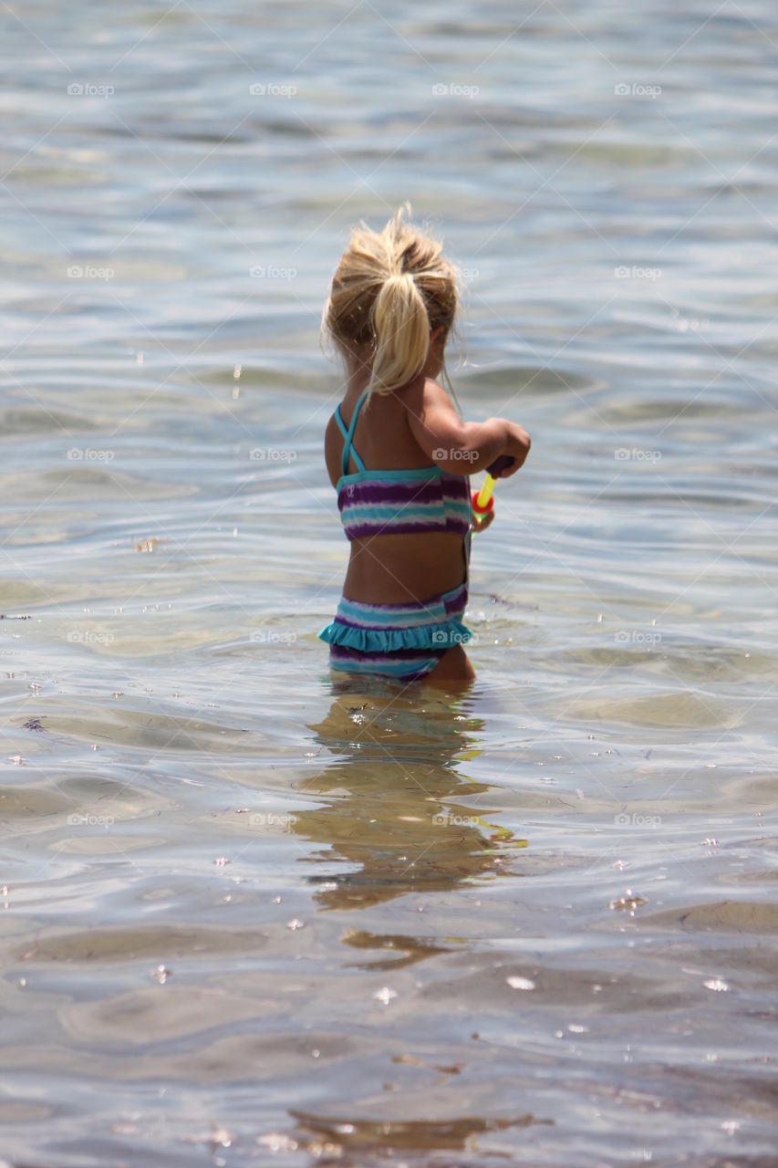 Little girl playing in the ocean