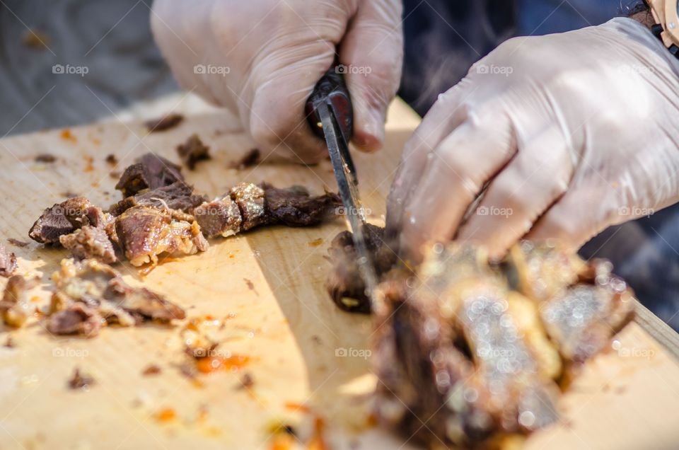 Close-up of person cutting meat