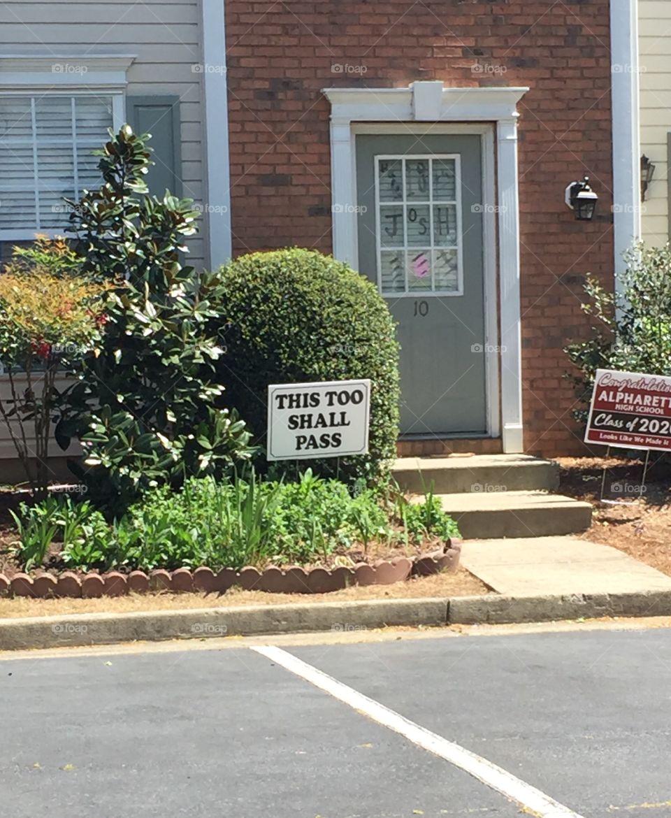 “This Too Shall Pass” sign on yard