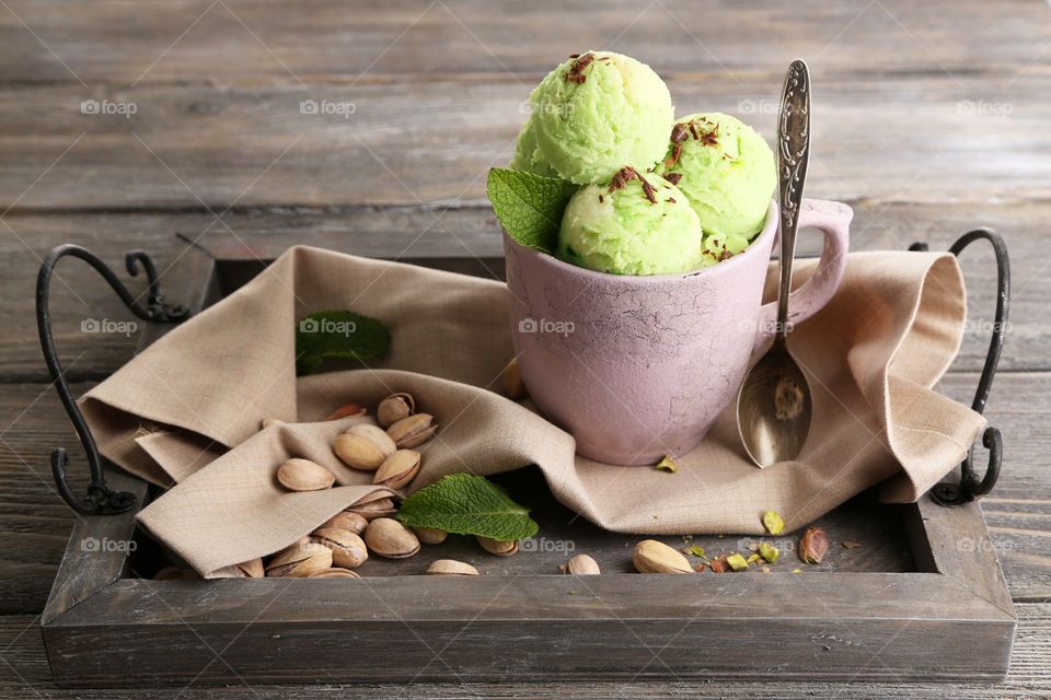 Pistachio ice cream scoops in cup