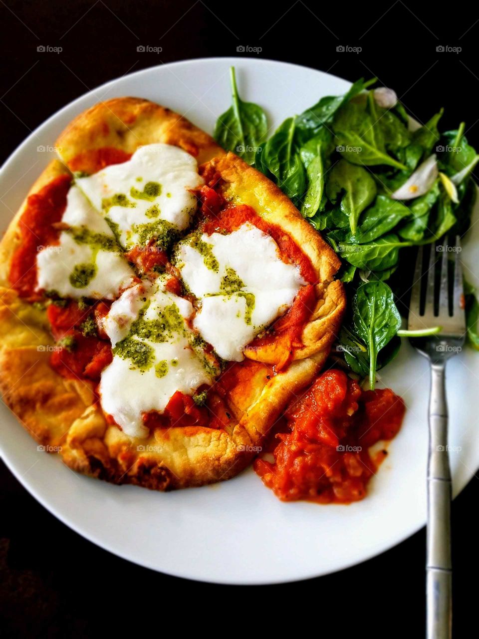 Salad and pizza in plate