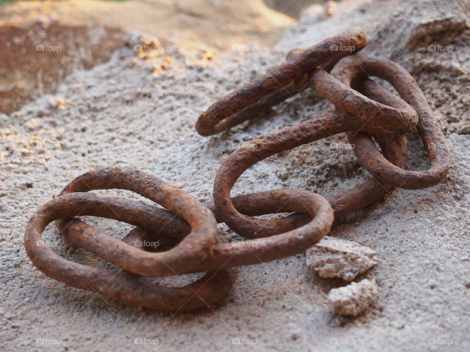 Old chain links on rock