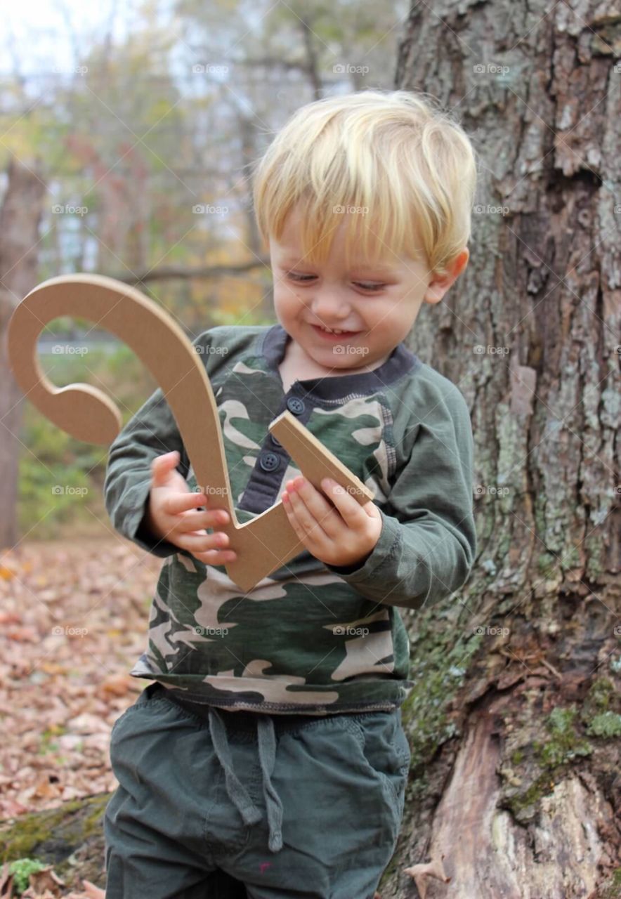 Smiling little boy holding number