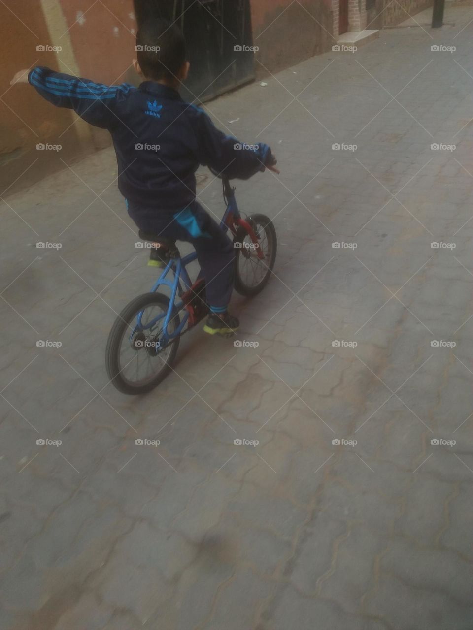 A young boy on bicycle.