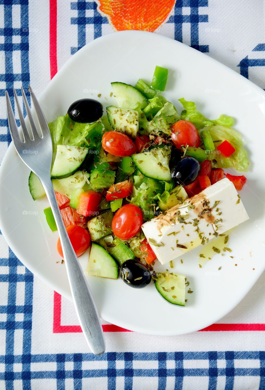 High angle view of greek salad with feta cheese