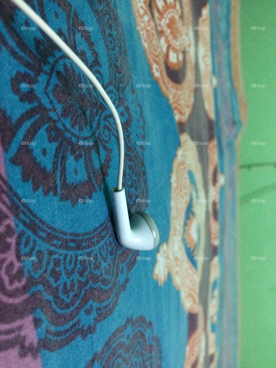 Close up of a white earphone on art sheet