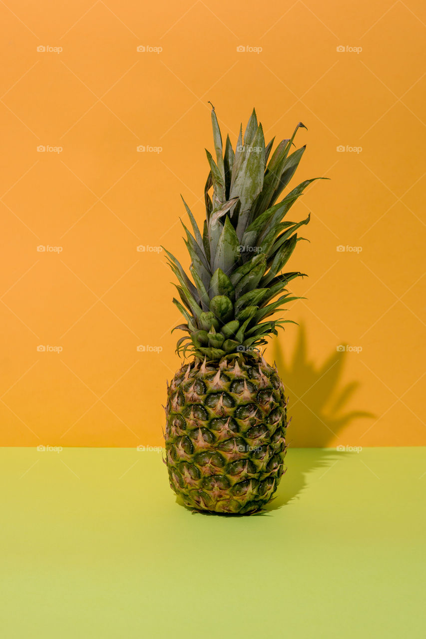 Pineapple on dual tone background