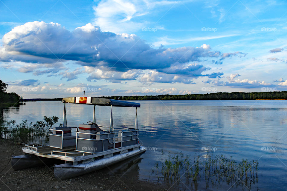 Pontoon boat on lake shore