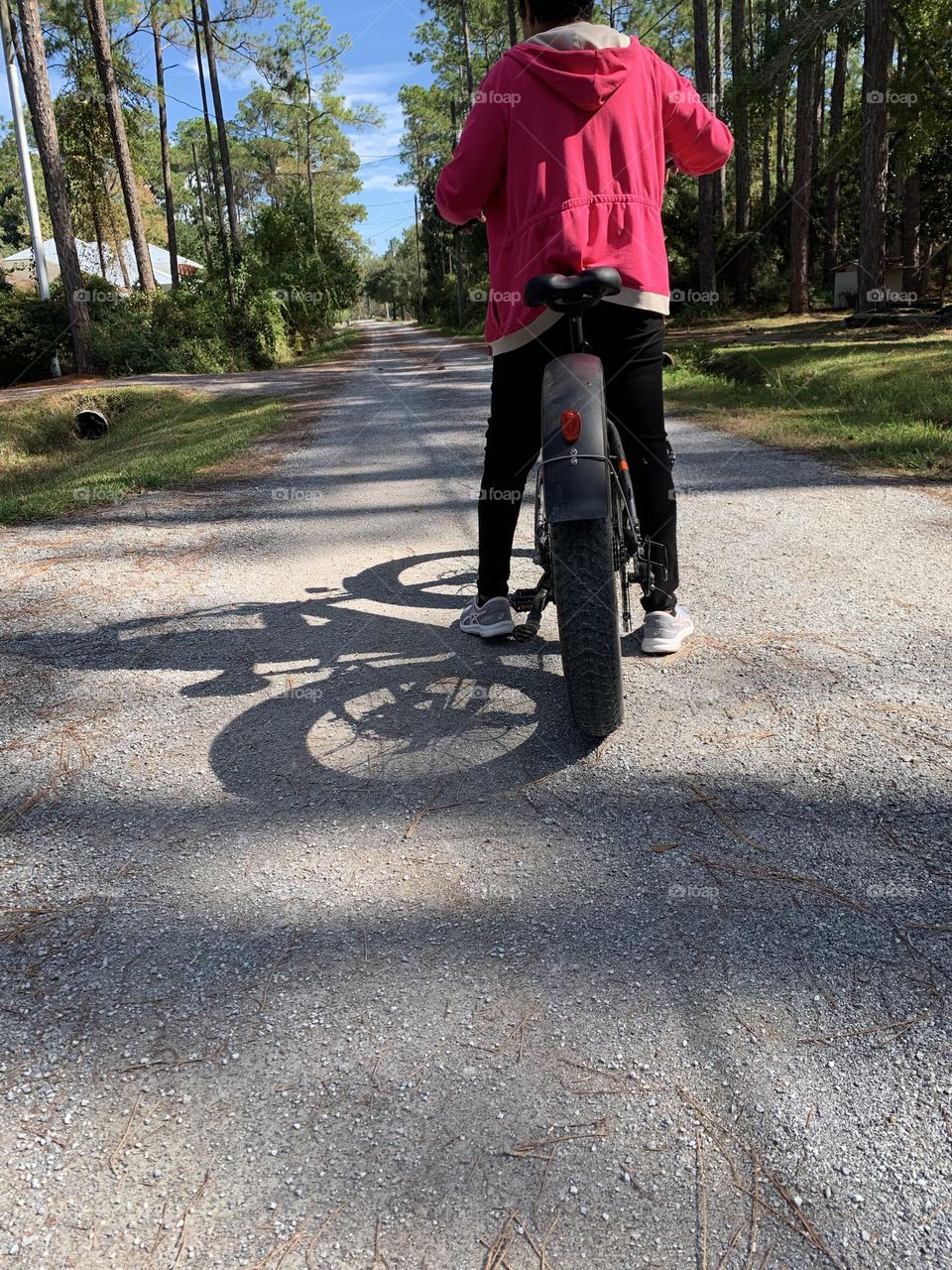 Women riding E-Bike - Scooters and Bicycles on city streets. The law allows people to operate bicycles with electric assist (e-bikes) on some streets and highways