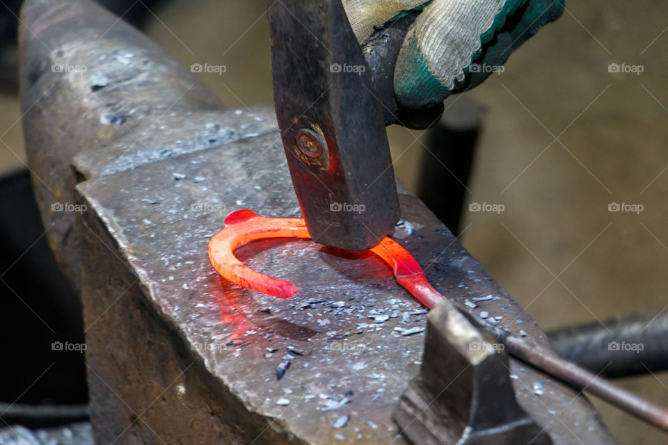 Blacksmith working in workshop