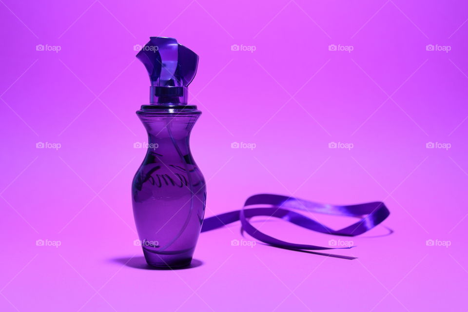 Perfume with a purple ribbon