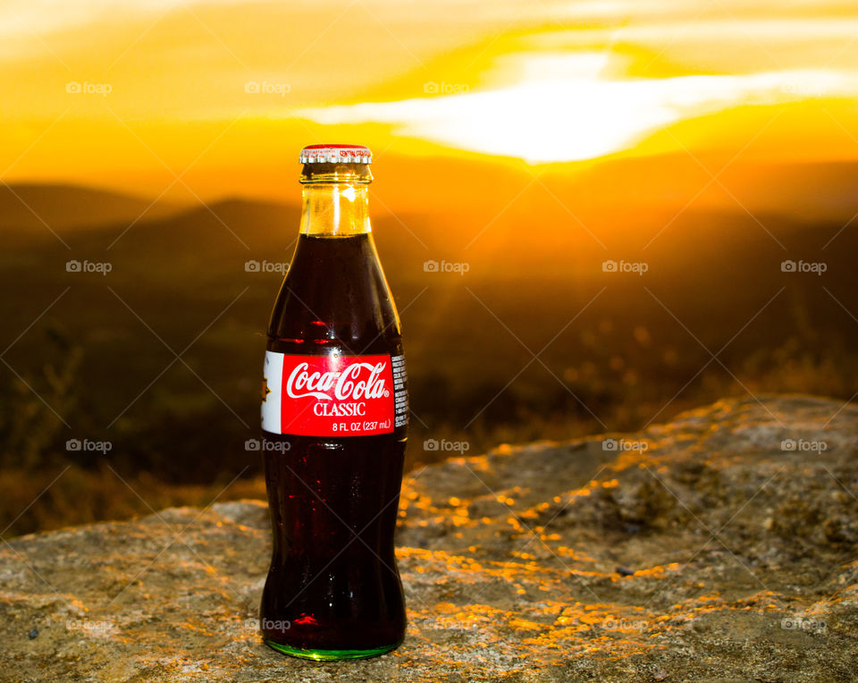 Bottle of Coke at sunset. 