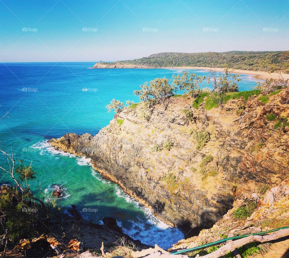 Cliffs, sea and crystal blue sea and skies at Hell’s Gate Noosa Australia 
