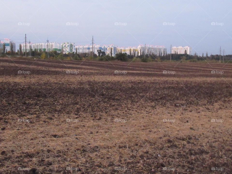 plowed field on the outskirts of the city of Voronezh, Russia, autumn, September, October, earth, sky