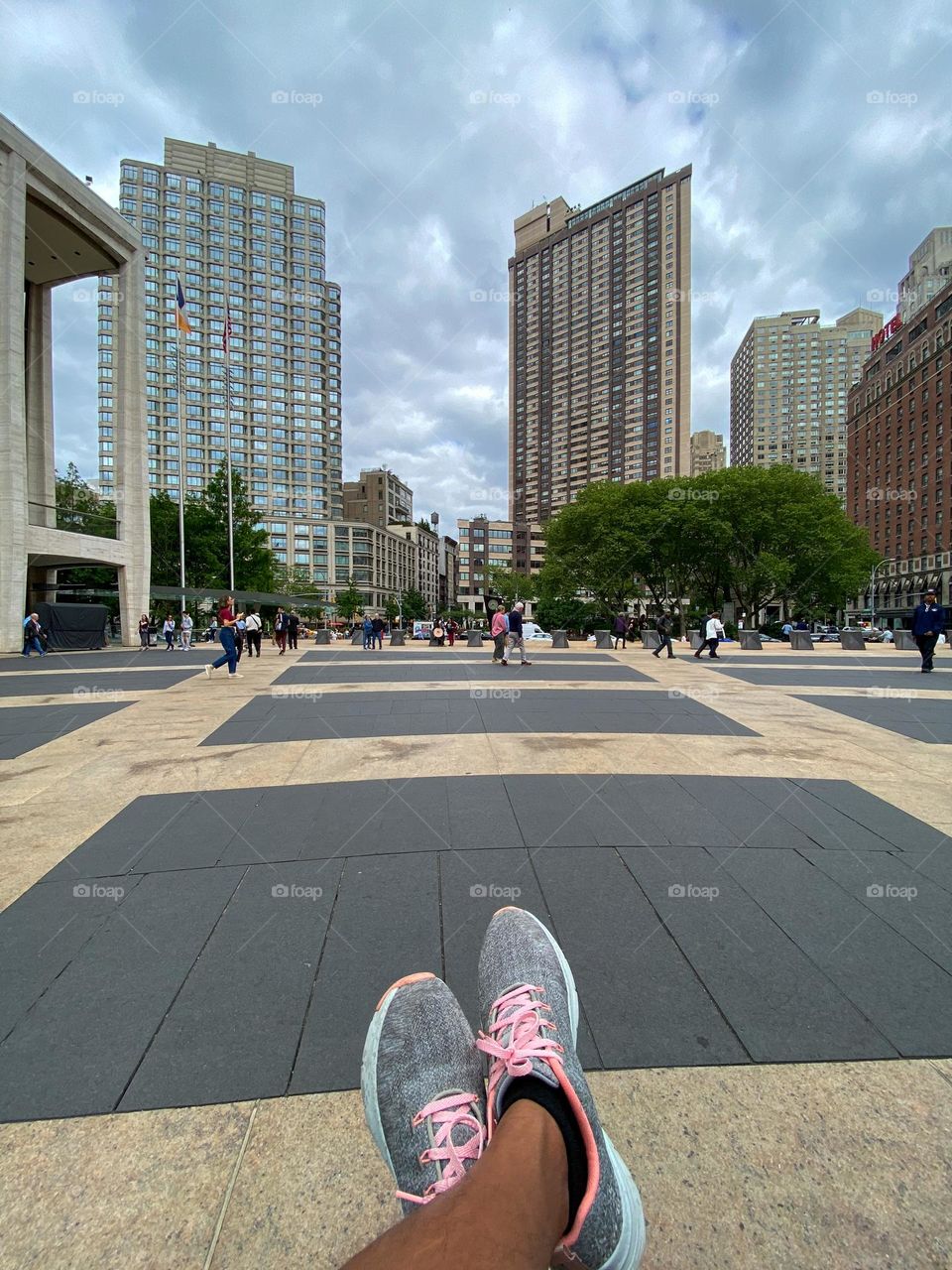 Office and apartment building, people walking across the Lincoln Center Manhattan New York. 