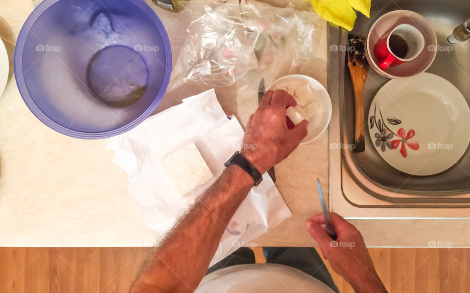 Man In The Home Kitchen Preparing Meal
