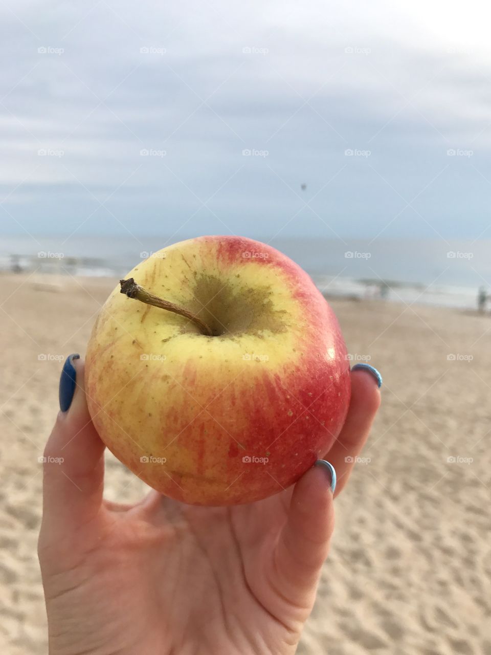 Apple in front of the sea