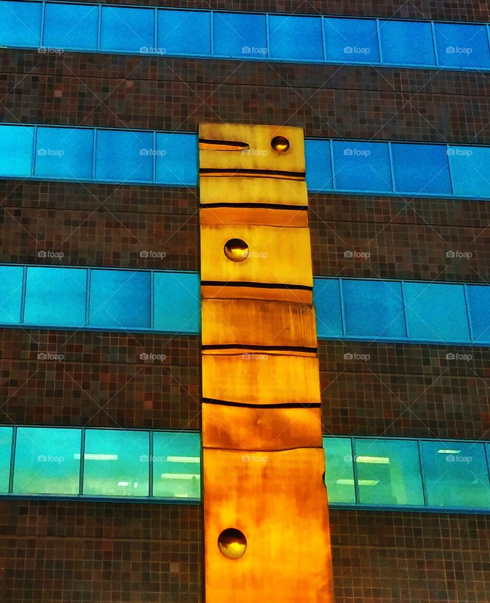 Golden Sculpture against Blue Glass