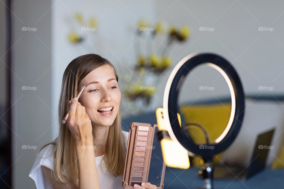 Woman applying makeup 