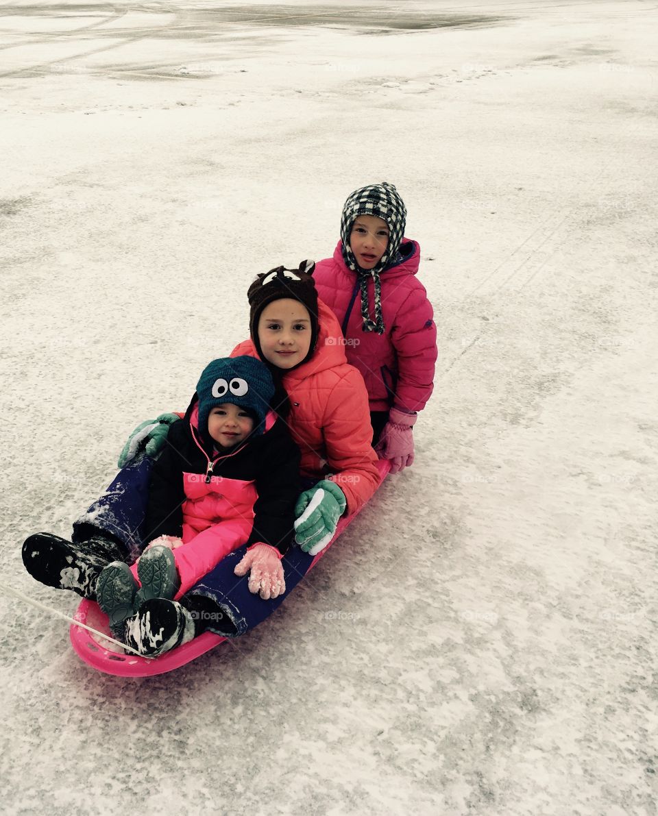 Riding a sled in the snow.