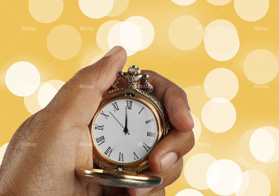 New year concept antique golden watch in a hand