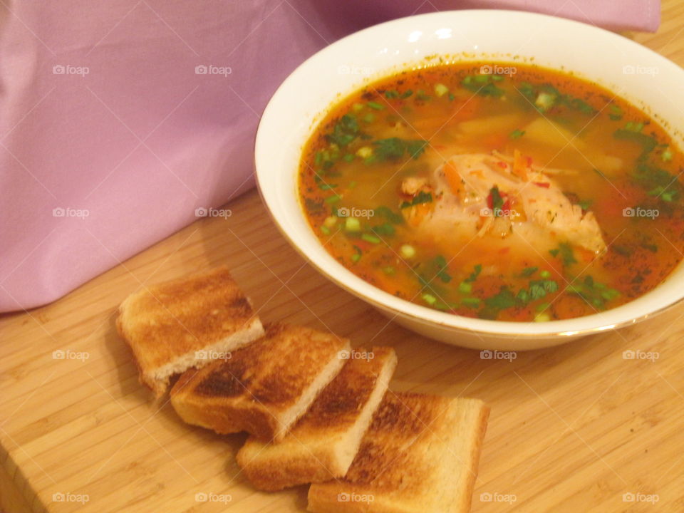 Chicken soup with parsley and toast bread