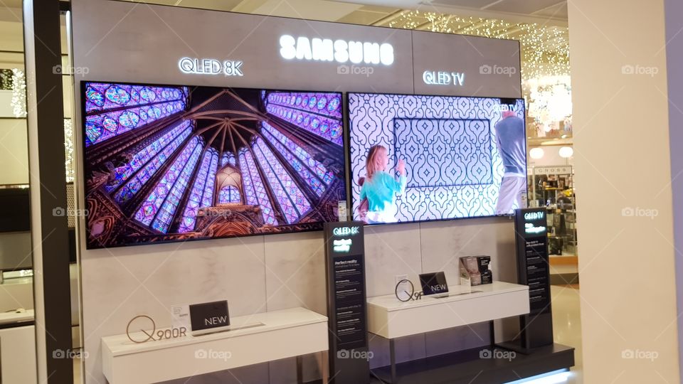 Samsung QLED mounted 8K and 4K UHD televisions displayed in the experience zone at Peter Jones Sloane square Kings road Chelsea London