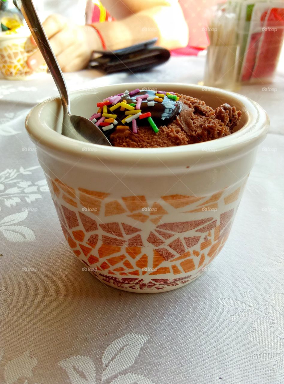 chocolate ice cream in a bowl on the table