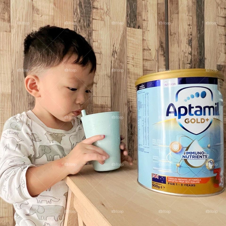 Happy boy with his favourite growing up milk formula 