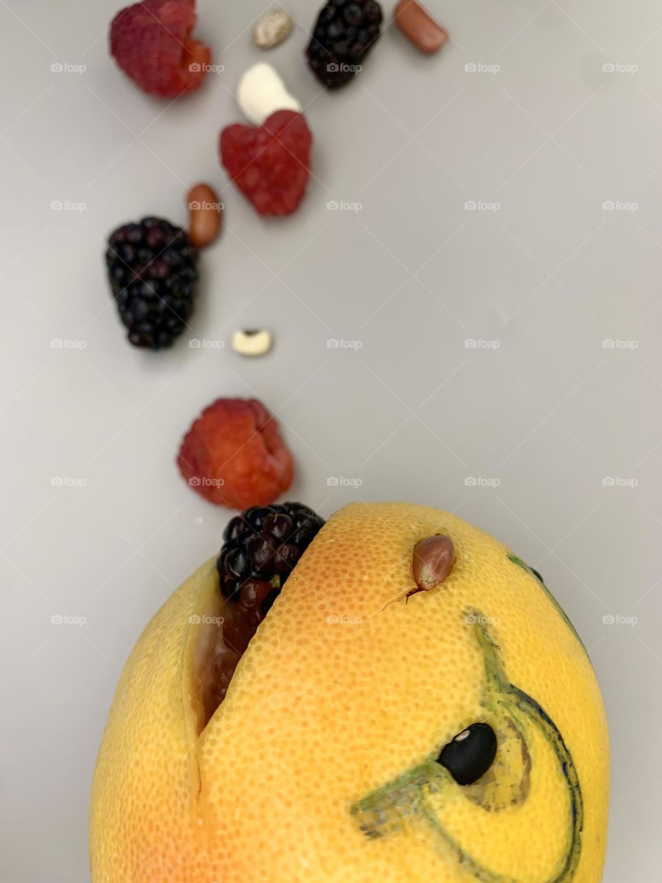 Grapefruit Character Eating Falling Berries And Beans Including Raspberries And Blackberries.