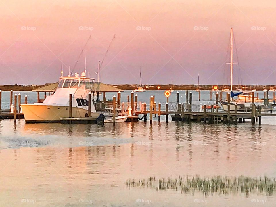 Sun setting into pastel glow over Matanzas River and island marina