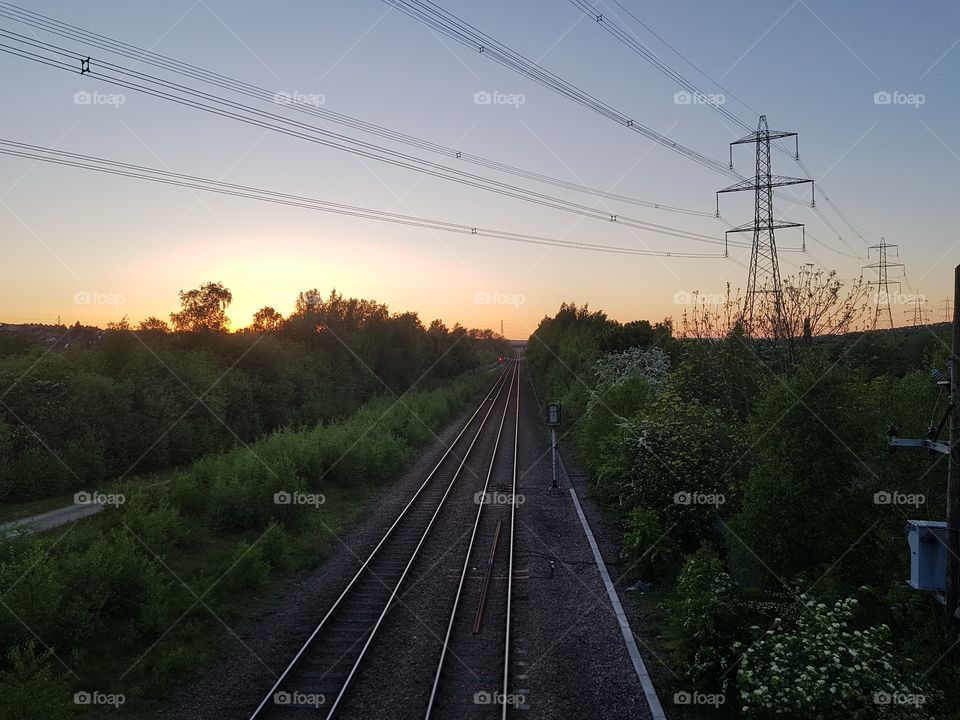 sunset over the top of rail tracks